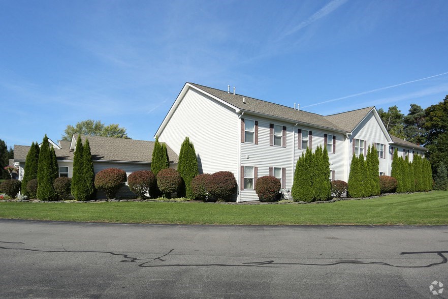 a large white house with a street in front of it