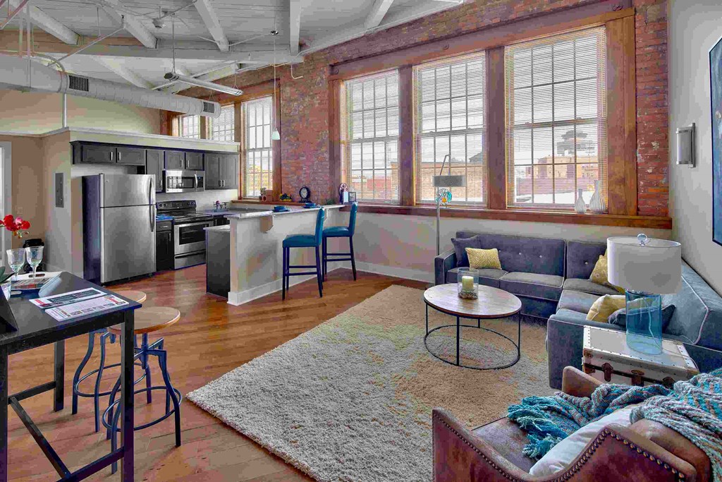 an open floorplan living room and kitchen in a loft apartment