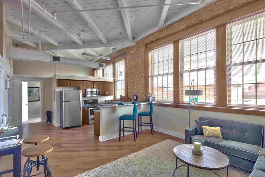 an open living room and kitchen with a large window