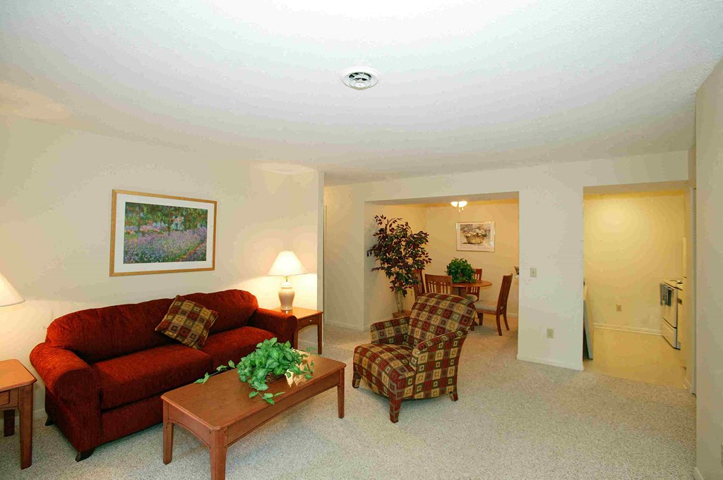 a living room with a couch and a chair and a table