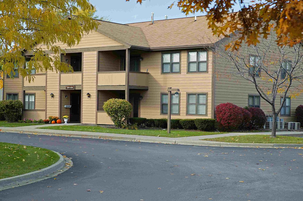 an apartment building with a street in front of it