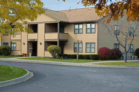 an apartment building with a street in front of it