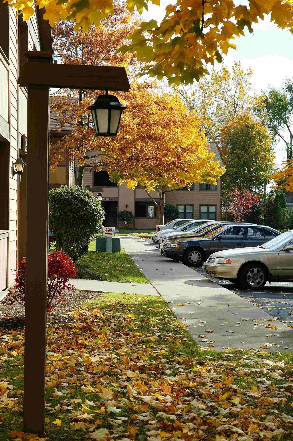 a street sign on a sidewalk in front of a building