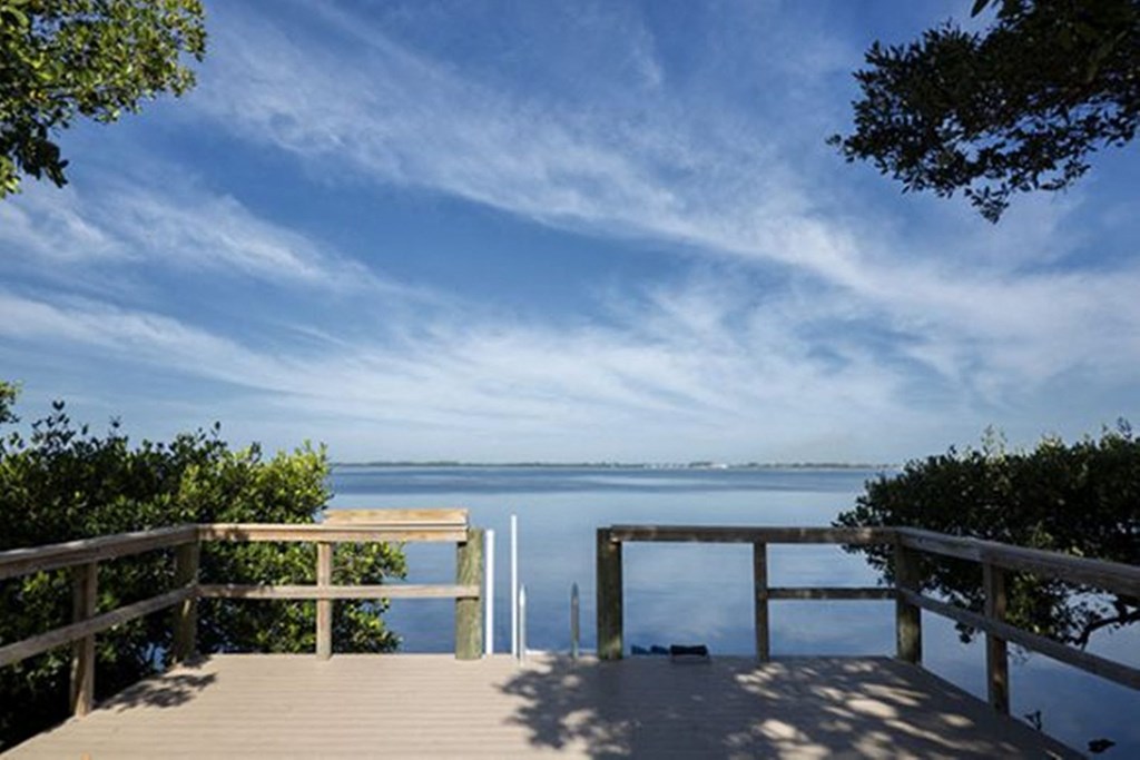 a view of a body of water from a wooden deck