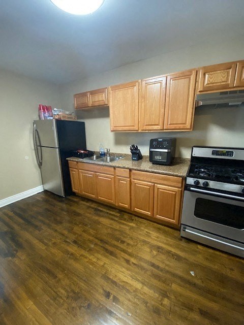 a kitchen with a stove and a refrigerator