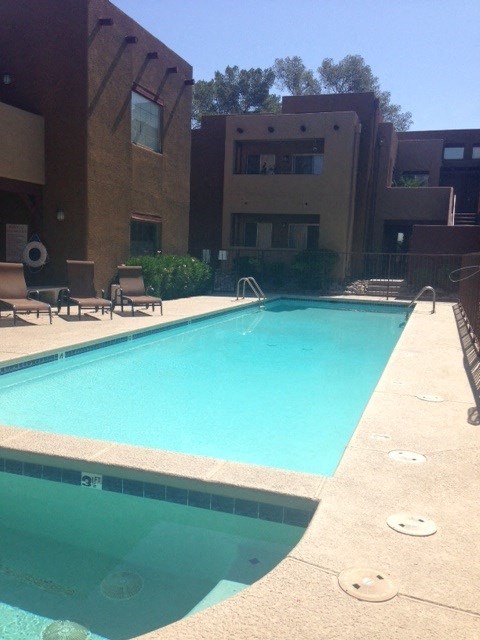 a swimming pool in front of an apartment building