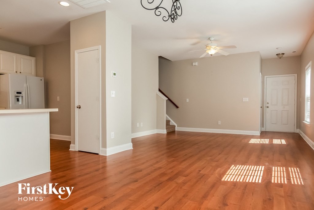 the living room and dining room of an empty house