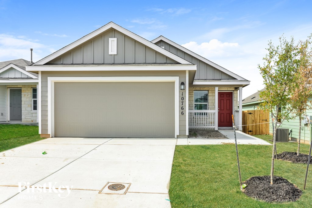 A house with a grey roof and a red door is shown.