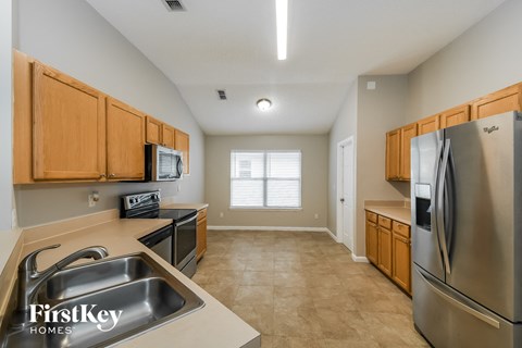 a kitchen with stainless steel appliances and wooden cabinets
