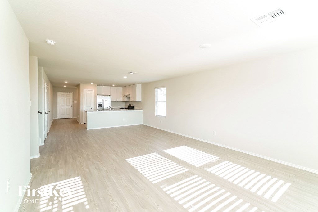 an empty living room and kitchen in a new home
