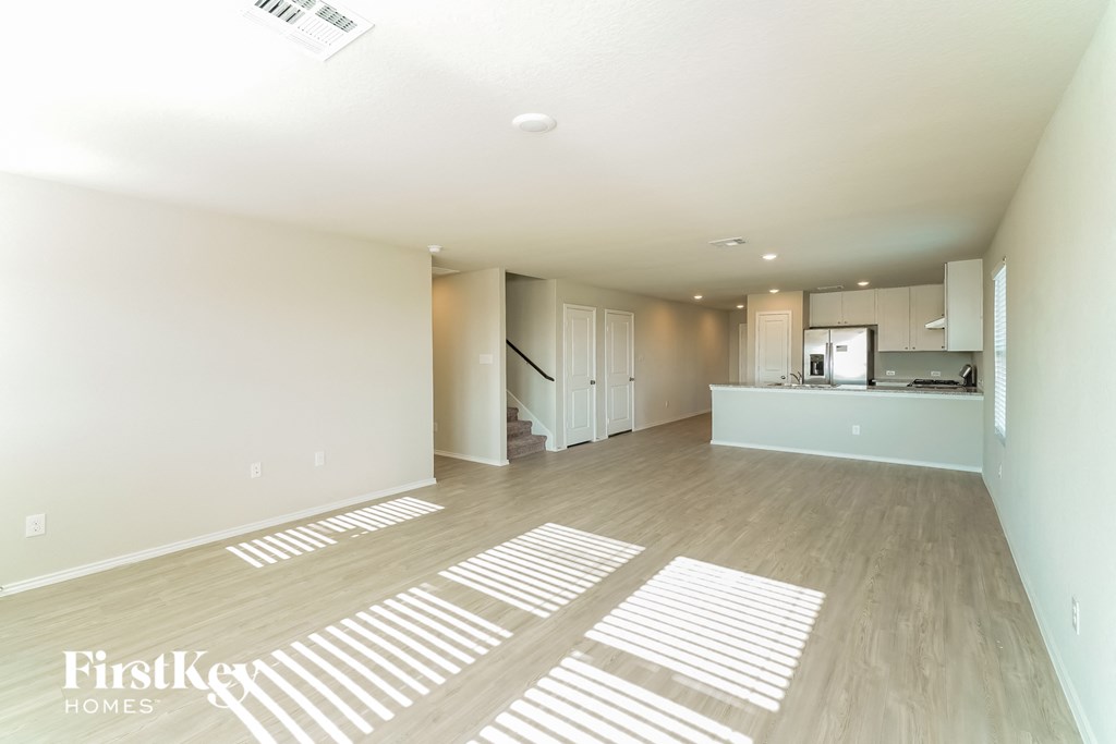 an empty living room and kitchen in a new home