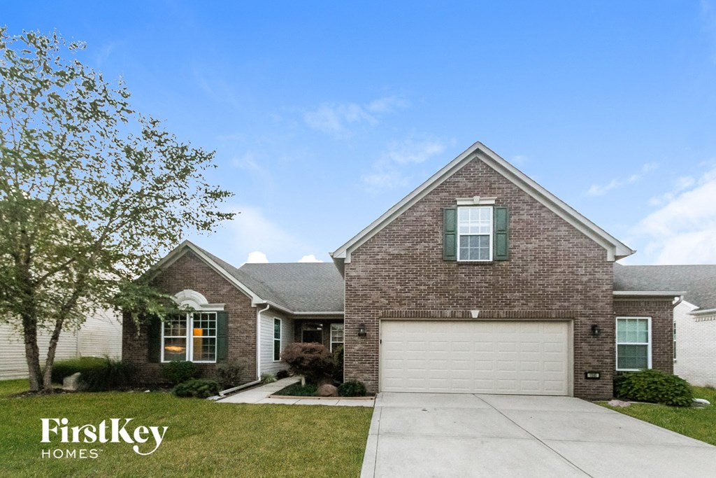 a brick house with a white garage door