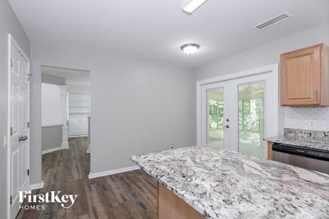 a kitchen with a marble counter top in a new home