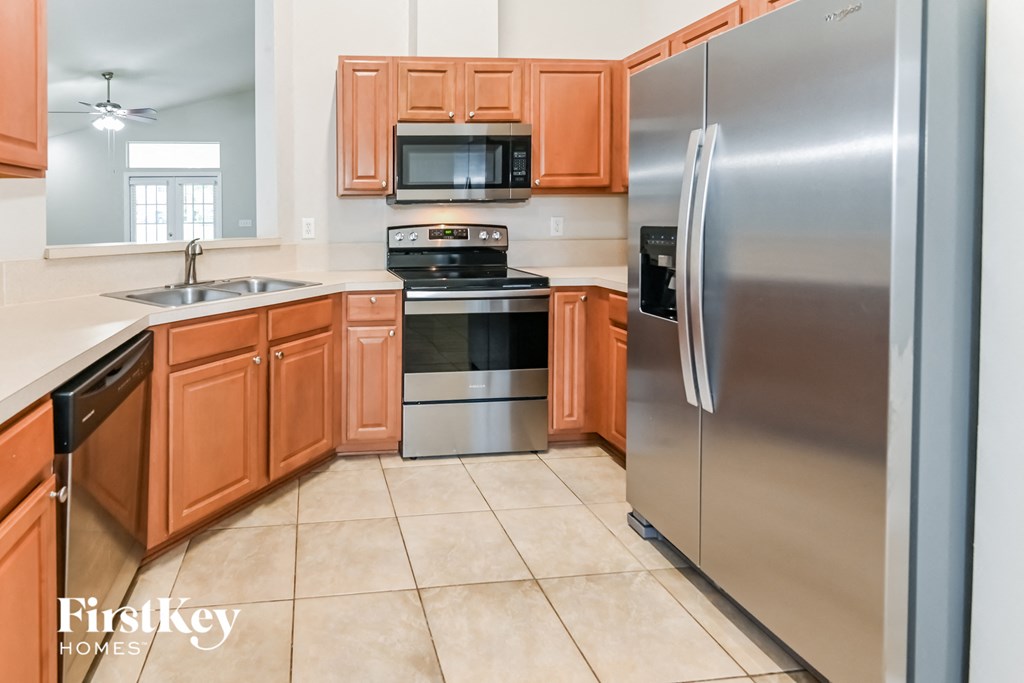 a kitchen with stainless steel appliances and wooden cabinets