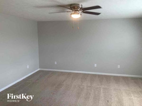 a empty room with a ceiling fan and a light