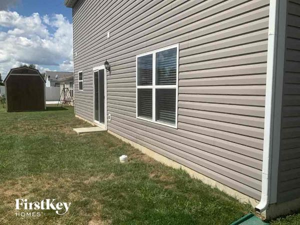 the side of a house with a door and a window