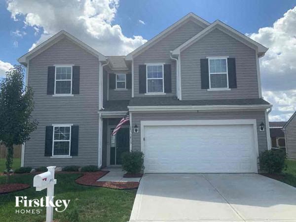 a beige house with a white garage door
