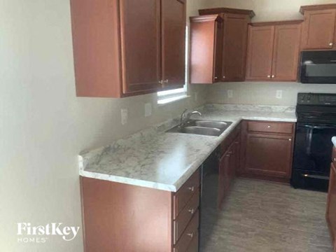 a kitchen with a marble counter top and a sink