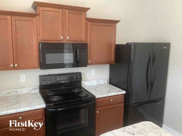 a kitchen with a stove microwave and refrigerator