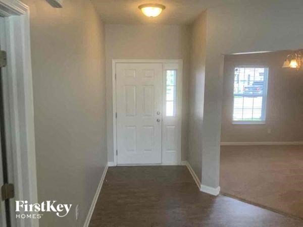 an empty living room with a white door
