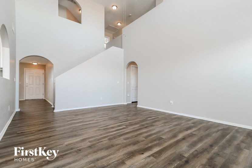a living room with white walls and wood flooring