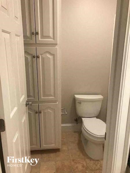 a small bathroom with a toilet and a closet