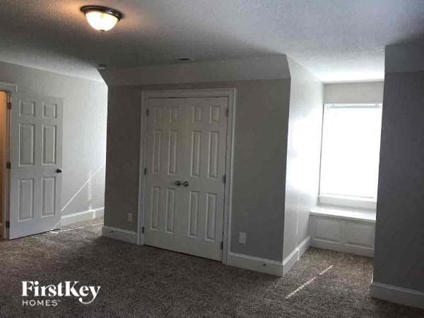 a empty room with two doors and a window