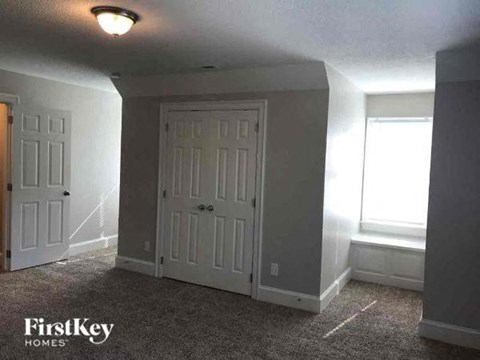 a empty room with two doors and a window