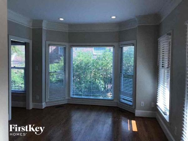 a living room with large windows and a wood floor
