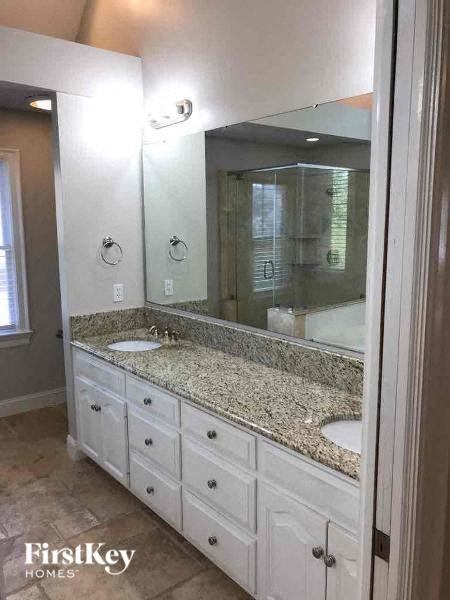 a bathroom with two sinks and a large mirror
