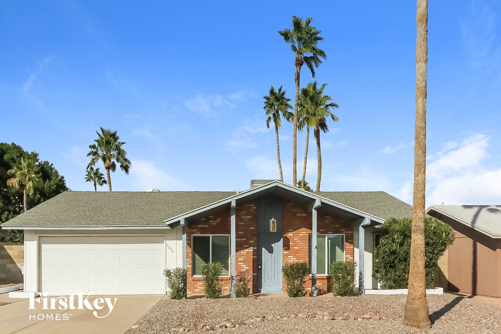a house with palm trees in front of it