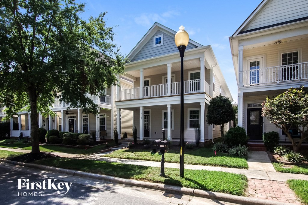 a large white house with a street light in front of it
