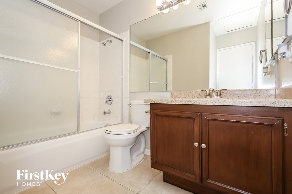 a bathroom with a toilet and a sink and a shower