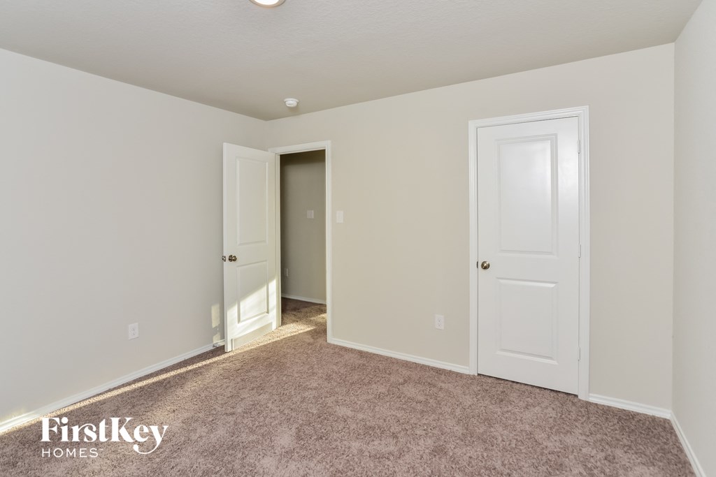 a bedroom with two closets and a door to a hallway