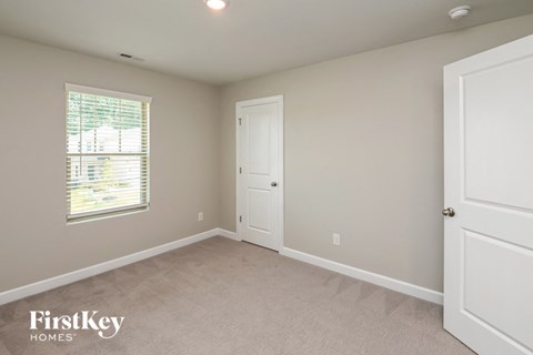 a bedroom with a white door and a window