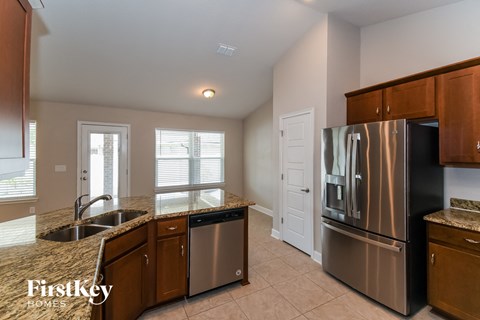 a kitchen with stainless steel appliances and granite counter tops