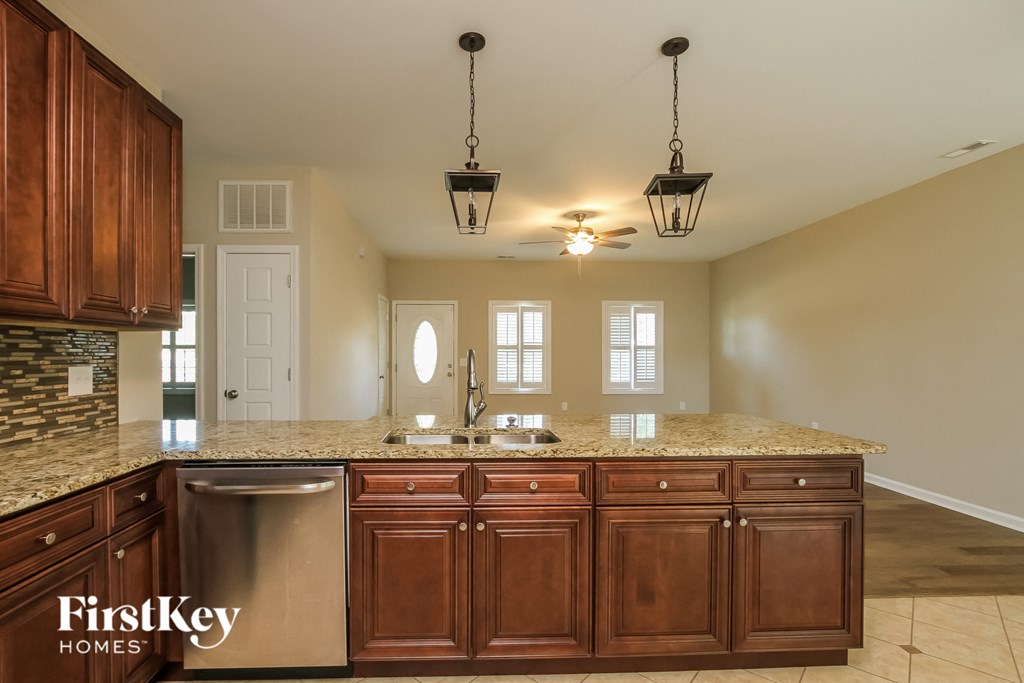 a kitchen with wooden cabinets and granite counter tops