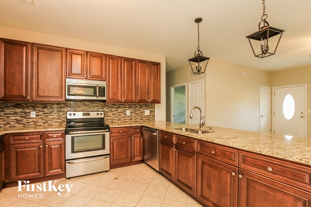 a kitchen with wooden cabinets and stainless steel appliances