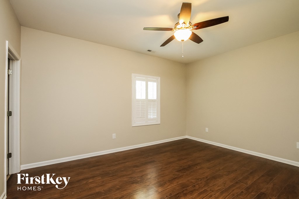 a living room with a ceiling fan and wood floors