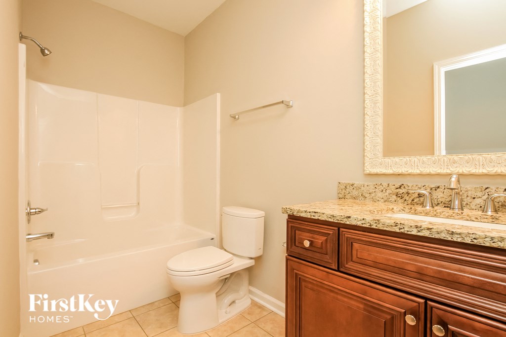 a bathroom with a toilet and a sink and a bath tub