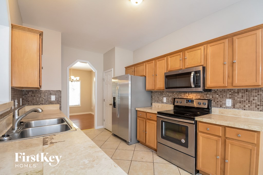 a kitchen with stainless steel appliances and wooden cabinets