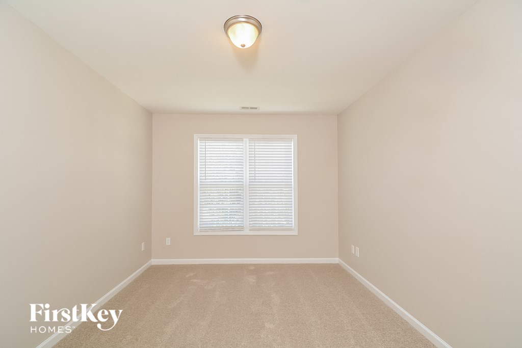 the second bedroom is clean and ready to be used as a play room