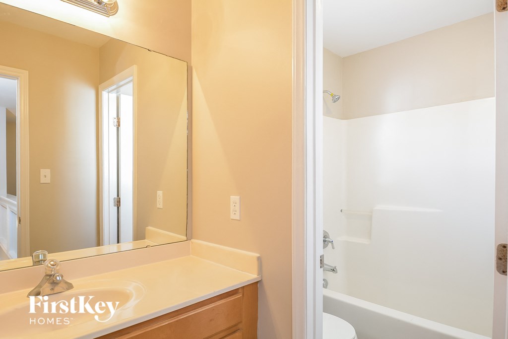 a bathroom with a mirror and a sink and a shower