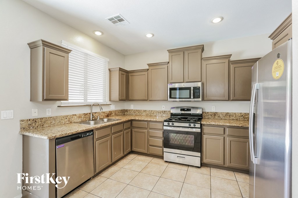 a kitchen with stainless steel appliances and granite counter tops