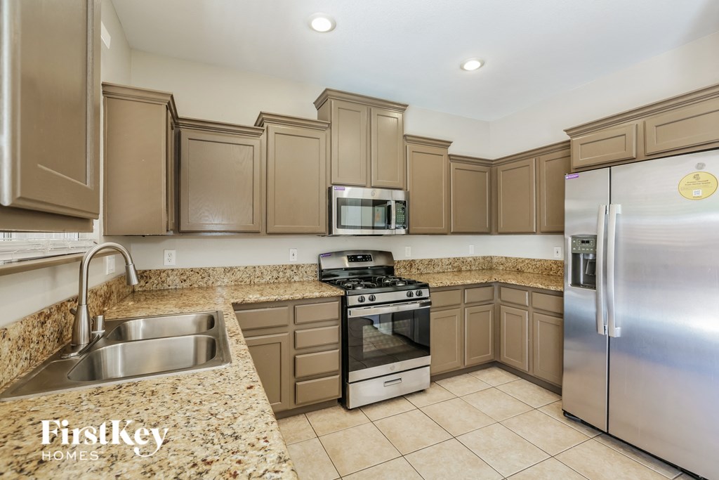 a kitchen with granite counter tops and stainless steel appliances
