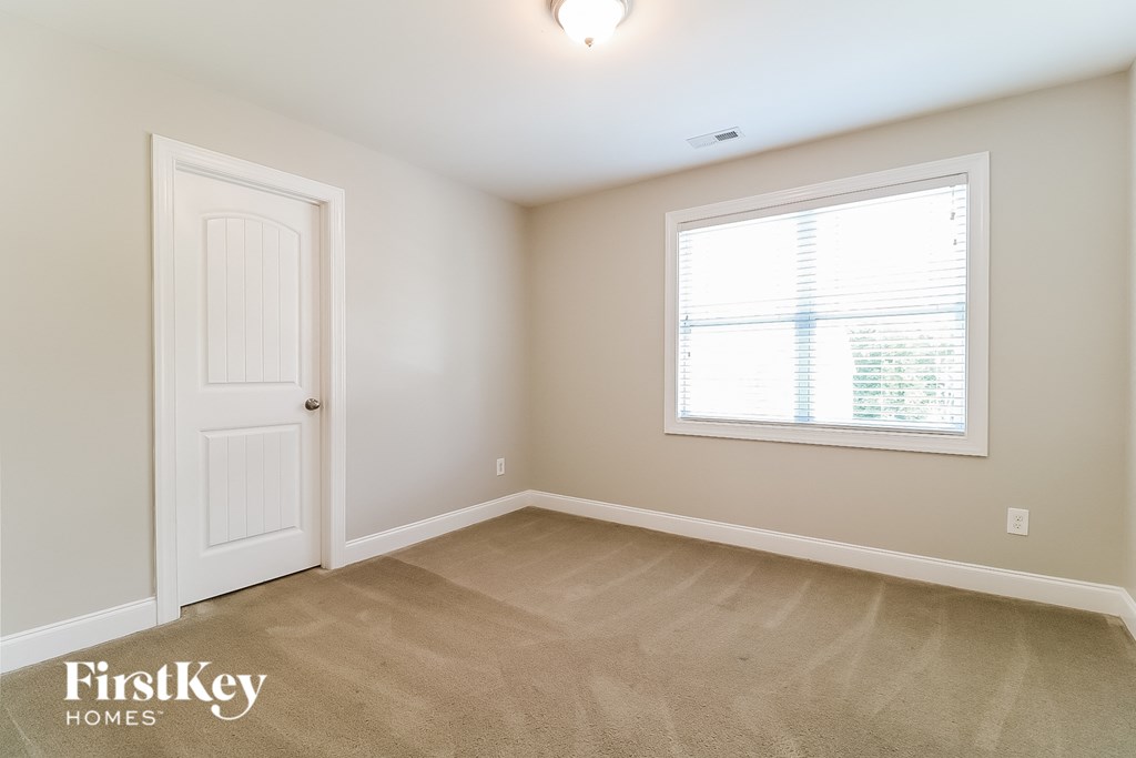 a bedroom with a white door and a window