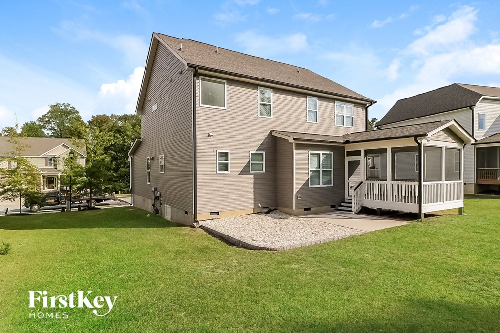 a house with a yard and a porch and a deck