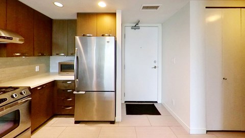 A kitchen with a stainless steel refrigerator and oven.