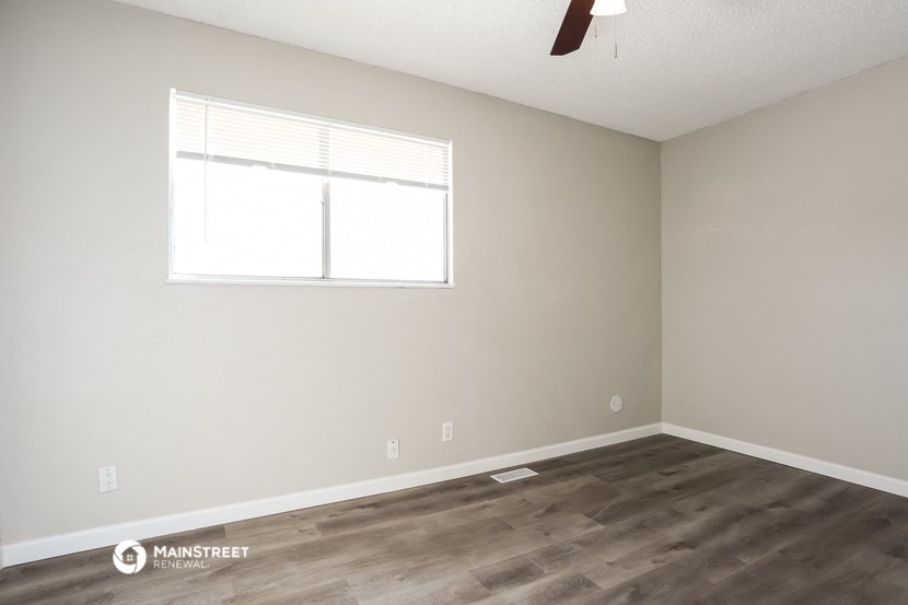a living room with wood floors and a window