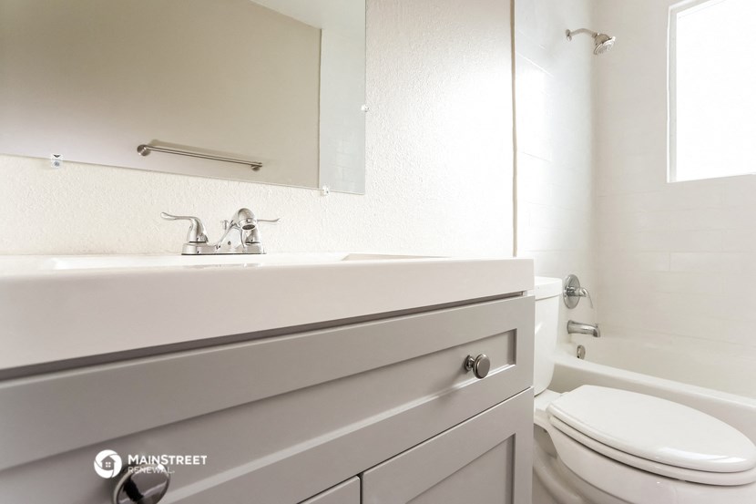 a white bathroom with a sink and a toilet